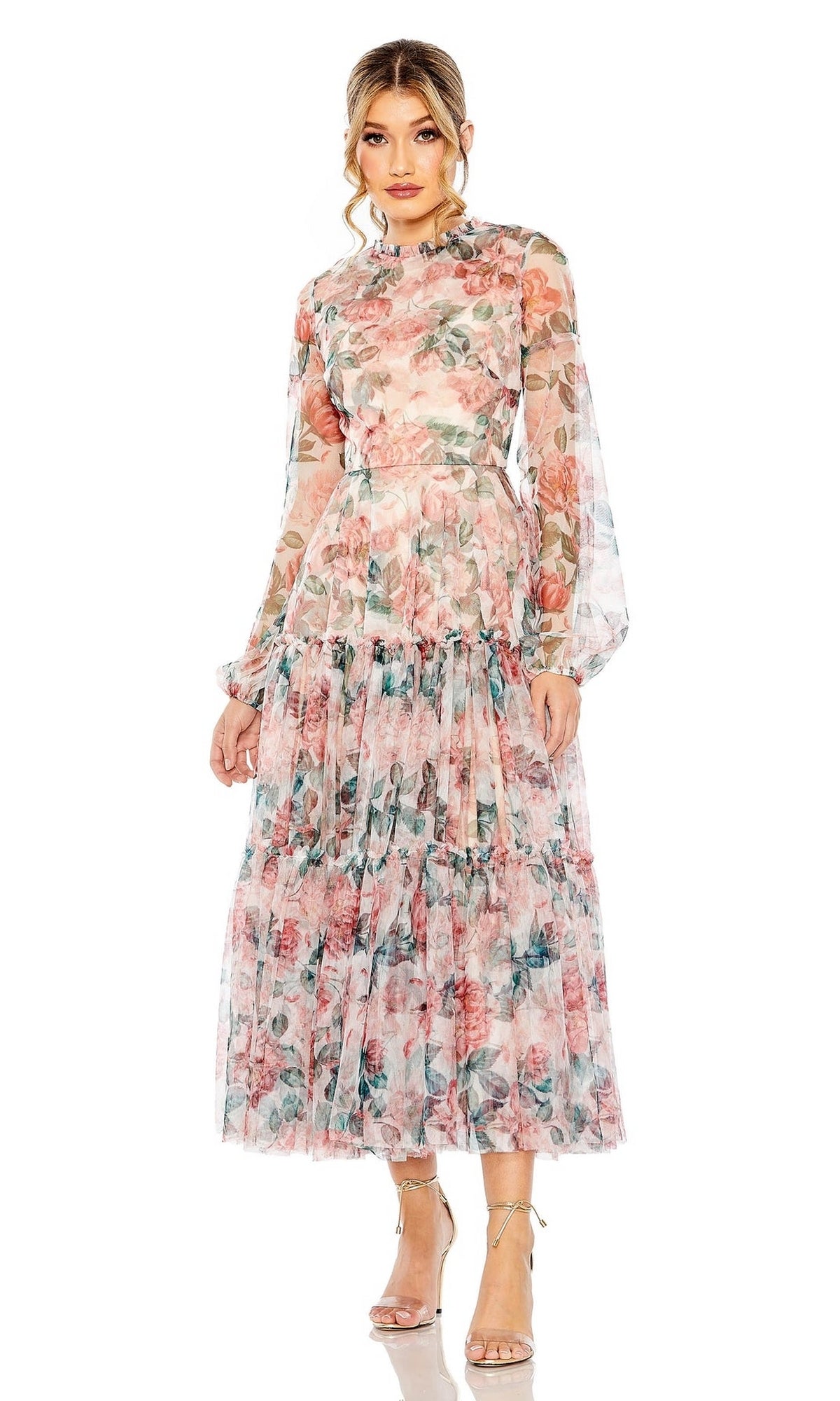 Model wearing the Mac Duggal 11405 Floral-Print Midi Party Dress with sheer long sleeves, high neckline, and ruffled skirt, paired with nude heels and posing against a white background.